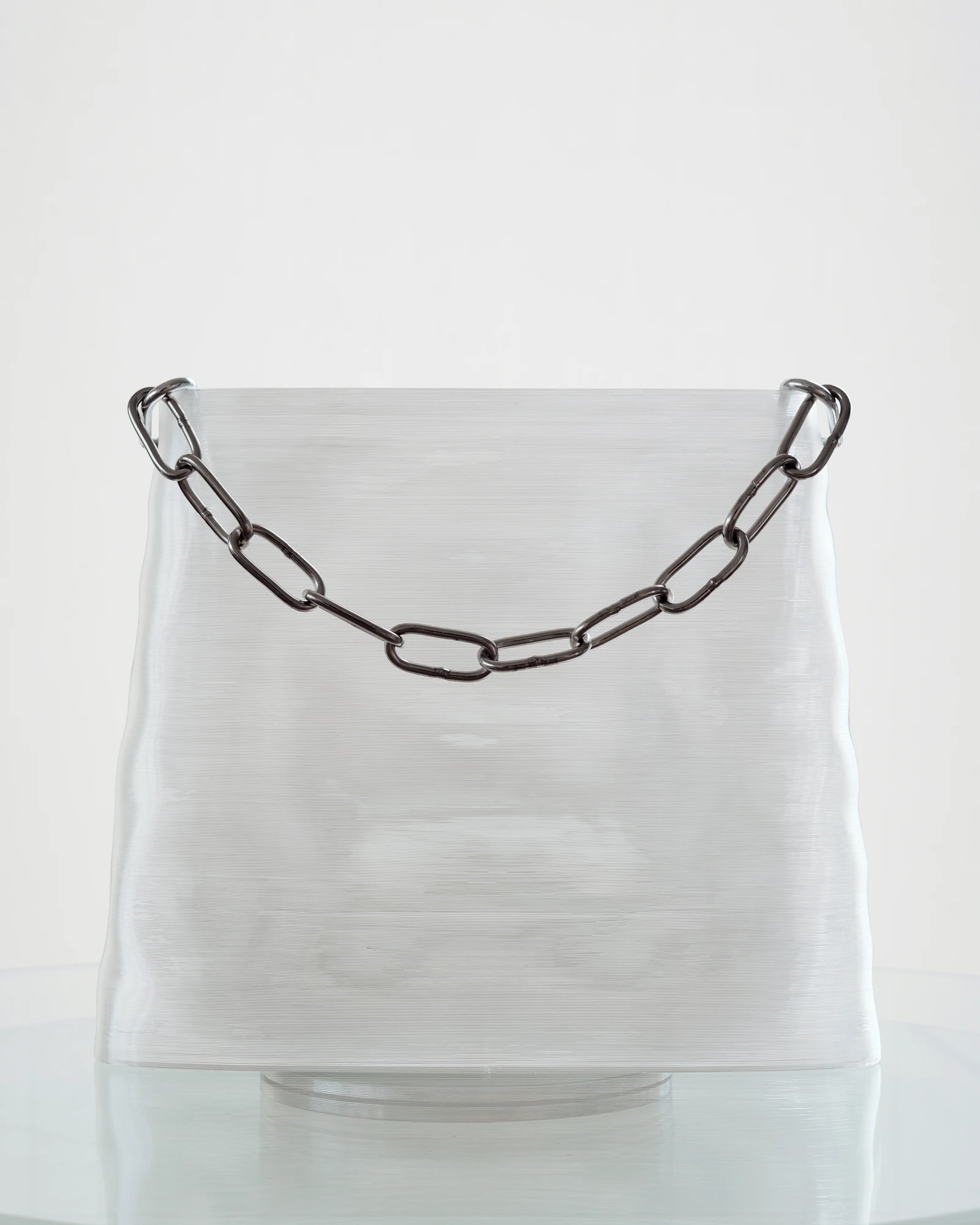 BG-001 front view, stainless chain draped across the clear printed body.